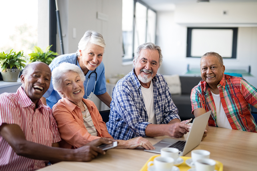 Portrait of smiling practitioner with multi-ethnic senior people